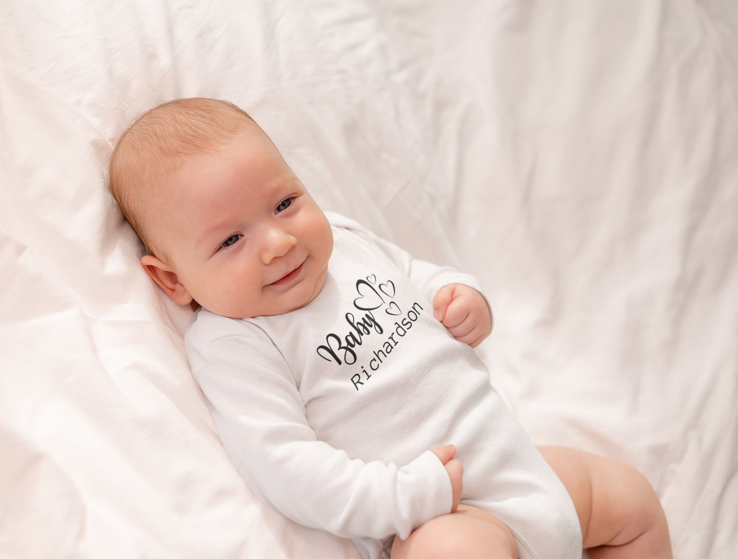 Surname and hearts baby vest